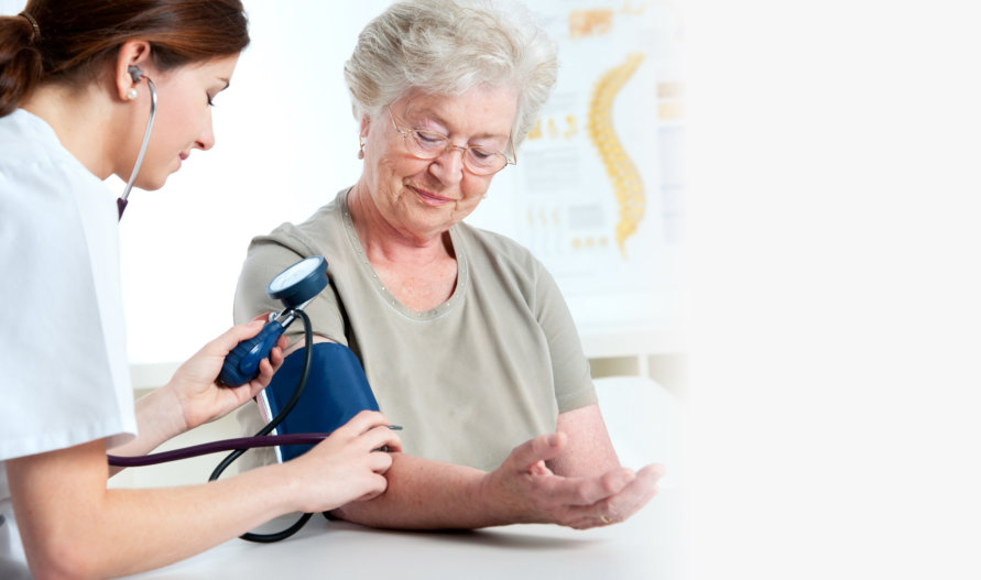 nurse checking on patient’s blood pressure